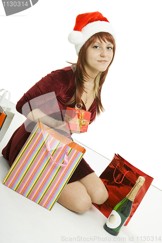 Image of The girl in a Christmas cap with purchases