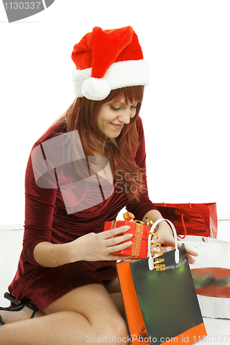 Image of The girl in a Christmas cap with purchases