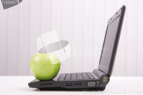 Image of The laptop and apple