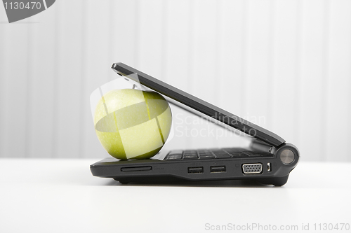 Image of The laptop and apple