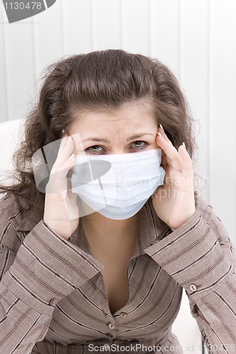 Image of The sick girl with medical mask with sad eyes