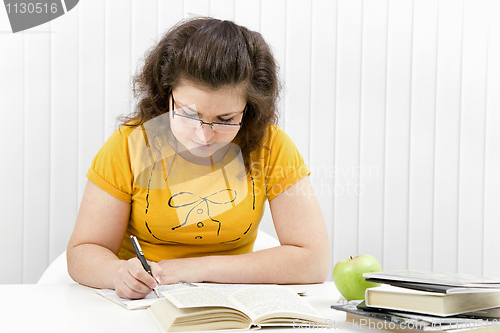 Image of The girl the student with writing-books and books