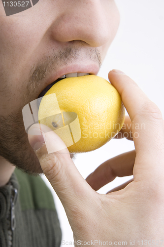 Image of The man bites lemon