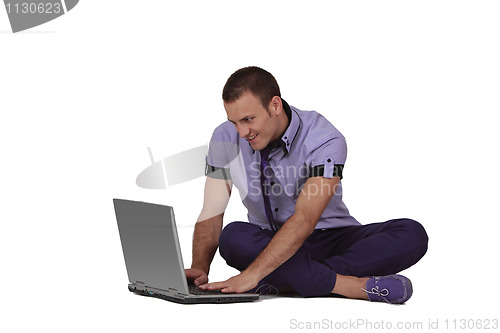 Image of Young man working on a laptop