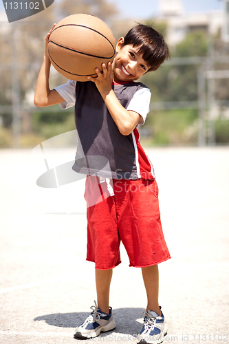 Image of Boy with basketball on his shoulders