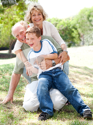 Image of Grandparents playing with grandson