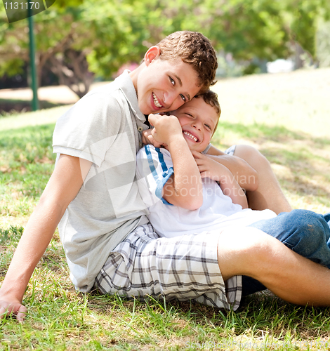 Image of image of brothers sitting outdoor