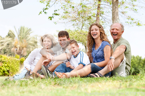 Image of Affectionate family having fun outdoors