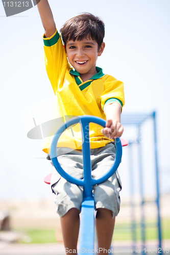 Image of Young kid enjoying swing ride