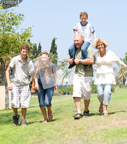 Image of happy family running towards camera