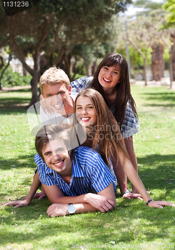 Image of Beautiful group of friends at the park