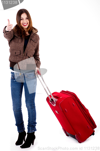 Image of young female traveller showing thumbs-up