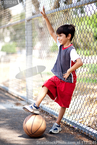 Image of Smiling young boy with his basketball