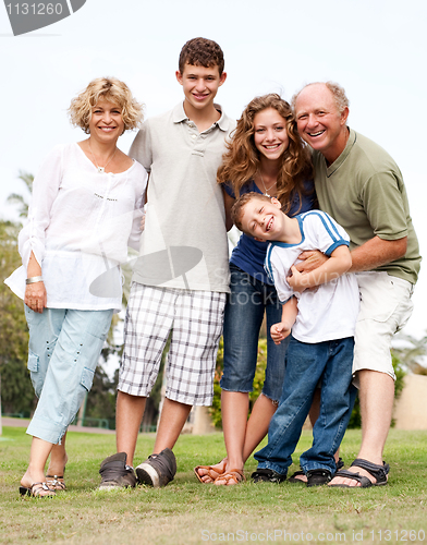 Image of Happy family having fun in the park