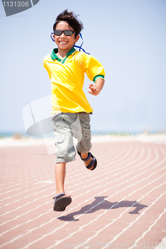 Image of Young kid running on race track