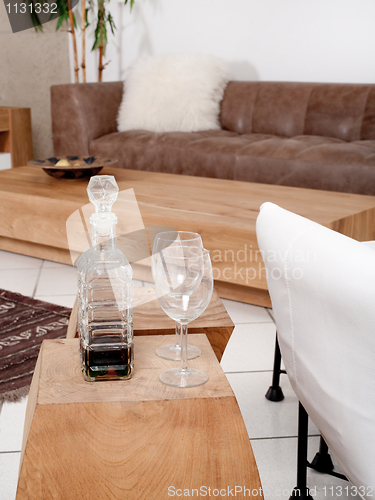 Image of Champagne glasses with modern couch in background