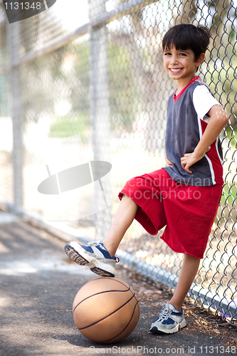 Image of Cute junior boy with basketball