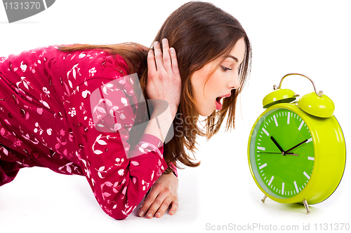 Image of lady looking at alarm clock