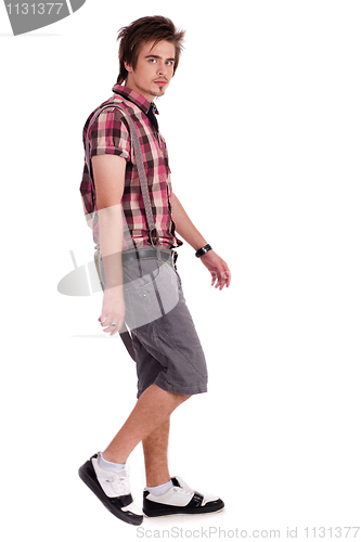 Image of Casual young guy in walking posture