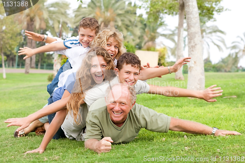 Image of happy family laying on each other
