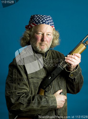 Image of handsome middle age man leather jacket  rifle