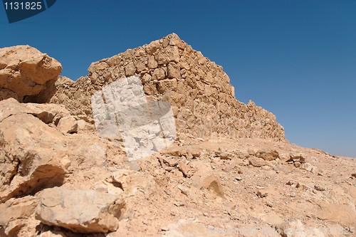 Image of Ruins of ancient stone tower on the desert hill 