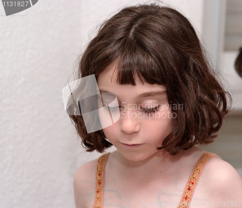 Image of Serious cute little girl looking down 