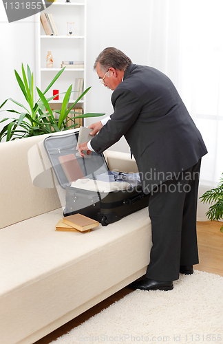 Image of Man packing books