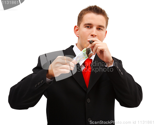 Image of Rich business man lighting cigar