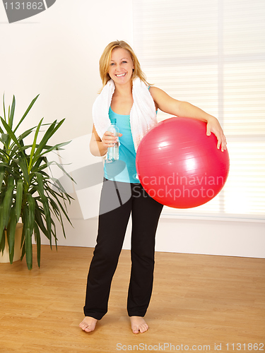 Image of Woman holding big red ball