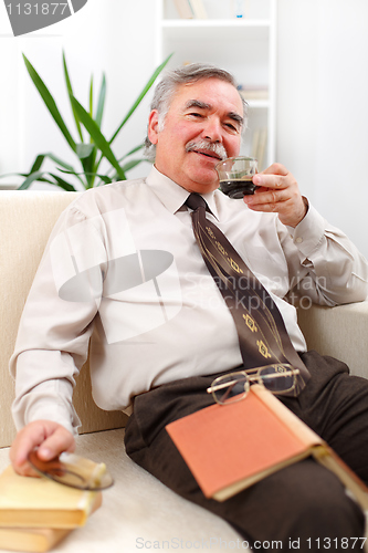 Image of Happy senior man drinking coffee
