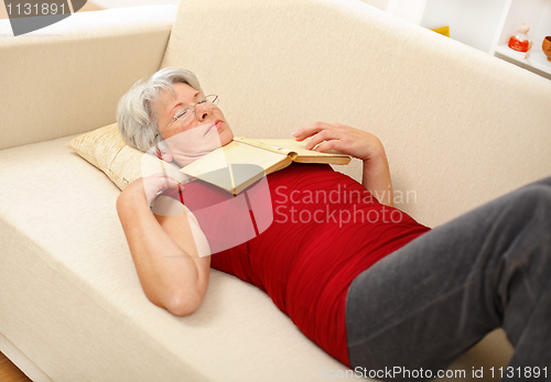 Image of Senior woman sleeping on sofa