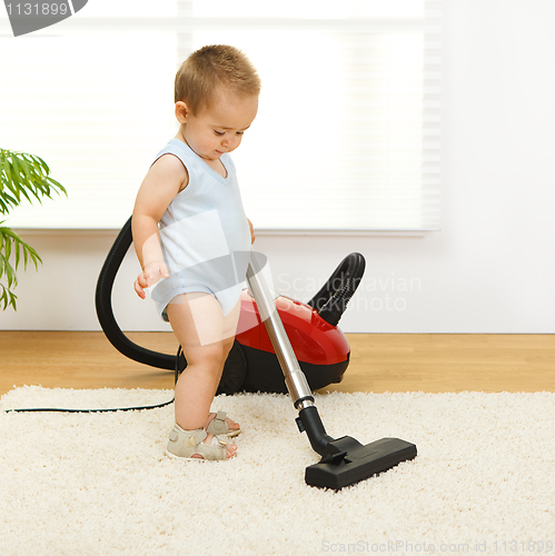 Image of Baby boy with vacuum cleaner