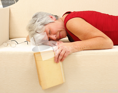 Image of Senior woman sleeping on sofa