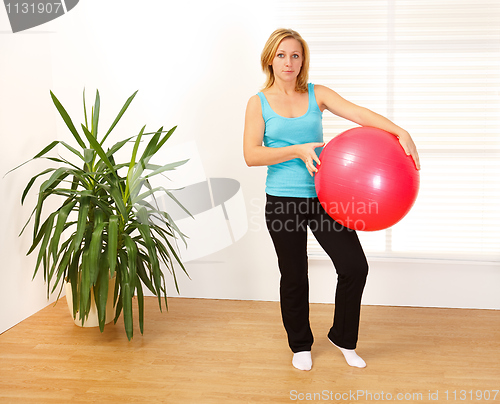 Image of Woman holding big red ball