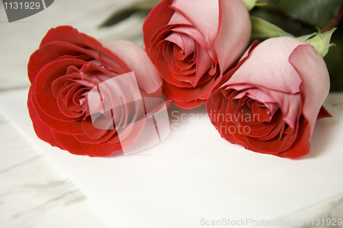 Image of Three red roses and note