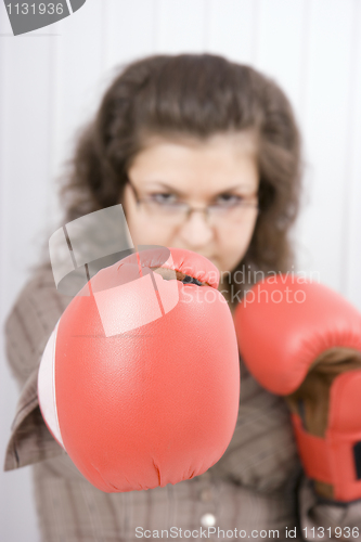 Image of The serious girl in boxing gloves