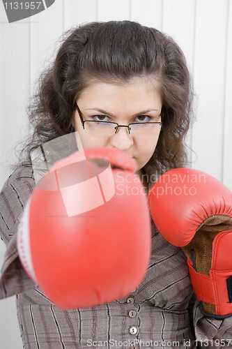 Image of The serious girl in boxing gloves