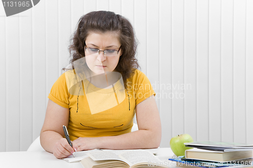 Image of The girl the student with writing-books and books