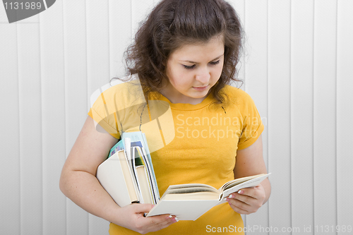 Image of young woman reading a book