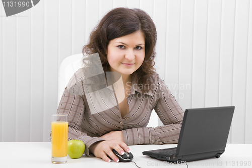 Image of The business smiling girl with the laptop