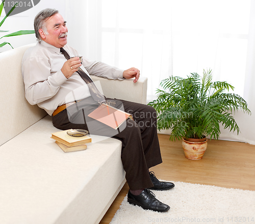 Image of Happy senior man drinking coffee