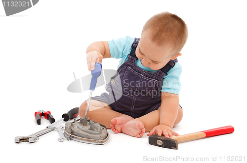 Image of Little boy playing with tools