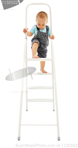 Image of Little boy climbing up on ladder