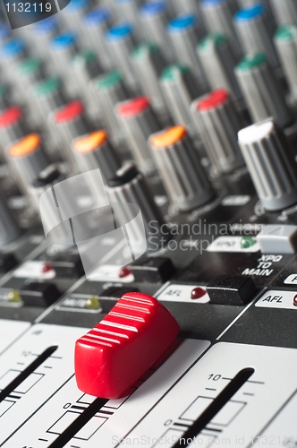 Image of Part of an audio sound mixer with buttons and a slider