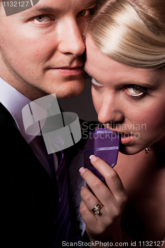 Image of Beautiful young bride holding her groom on a leash