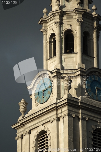 Image of Clock tower against dark sky with clock in the middle before sto