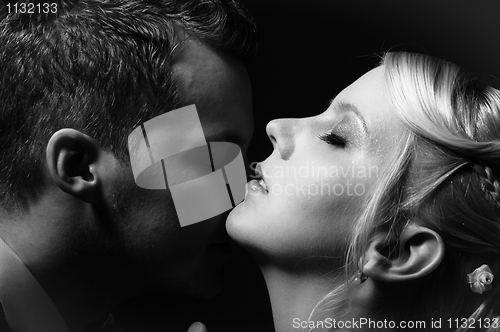 Image of Young couple kissing in black and white