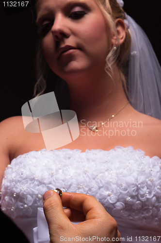 Image of groom proposing to her bride