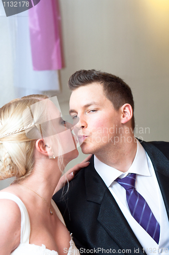 Image of Handsome groom kissing her bride